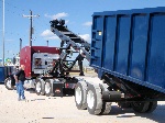 36 ft roll off trailer loading a 60 yds metal scrap container
