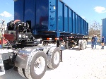 36 ft roll off trailer loading a 60 yds metal scrap container
